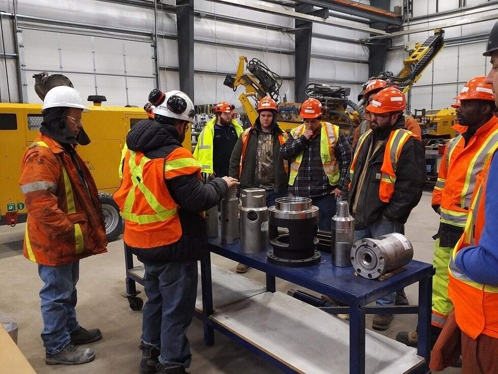 Operator trainees reviewing parts